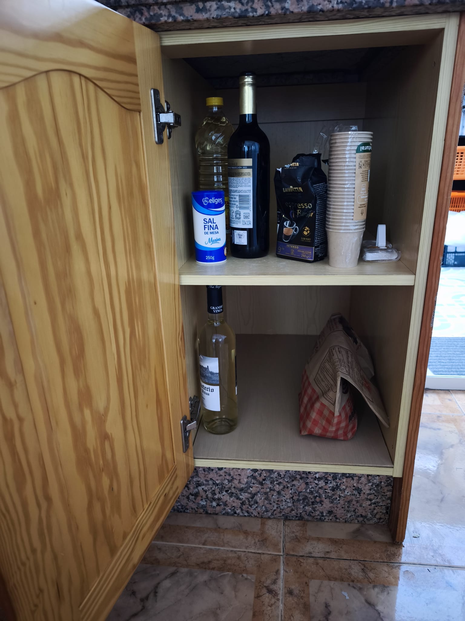 Kitchen cupboard stocked with basics